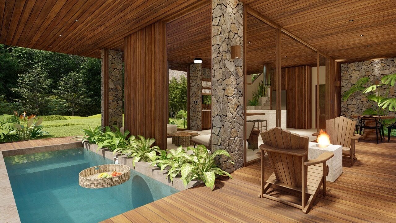 A poolside area with a wooden deck, stone pillars, and outdoor furniture.