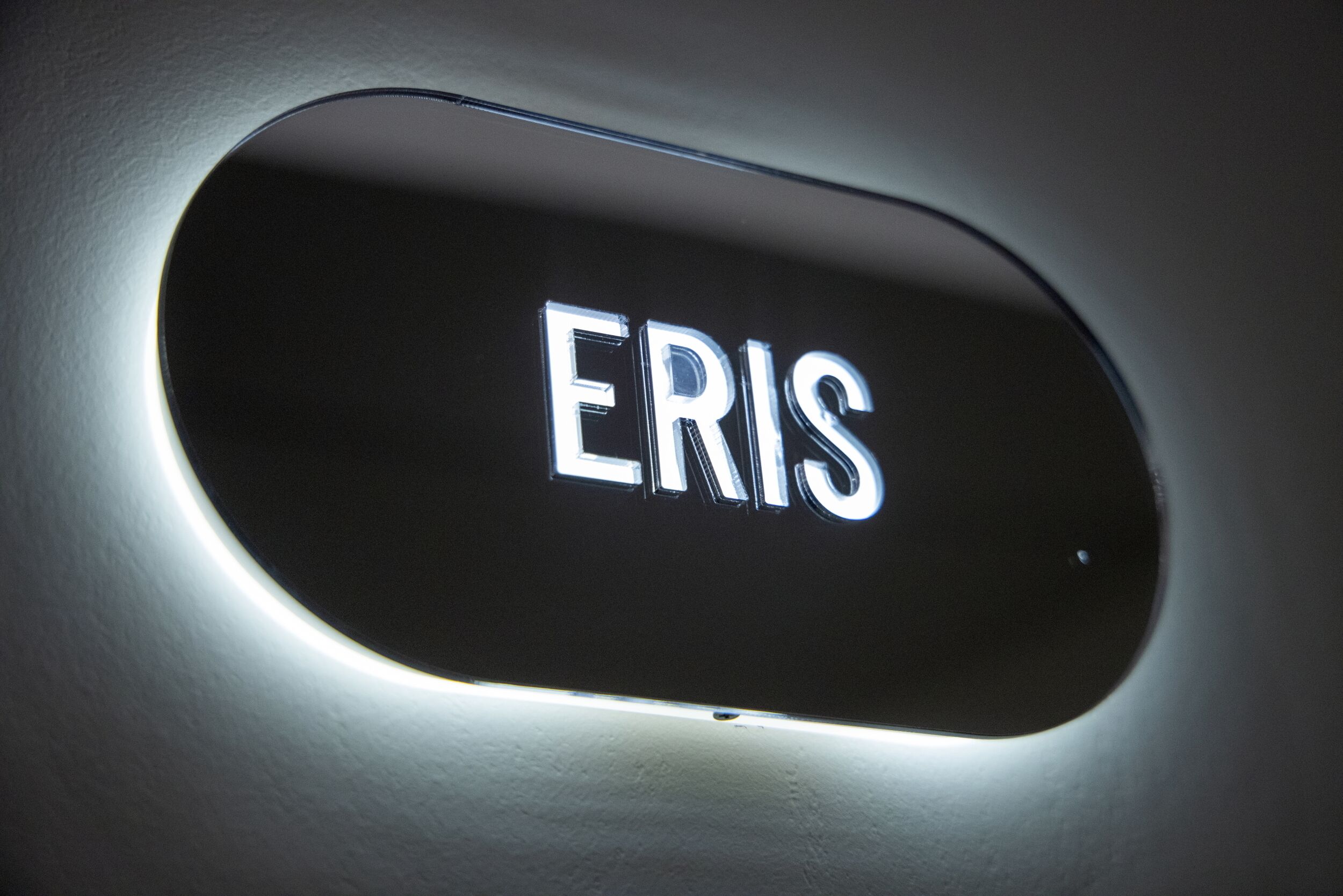 A sign with the word "ERIS" illuminated in a modern, sleek font.