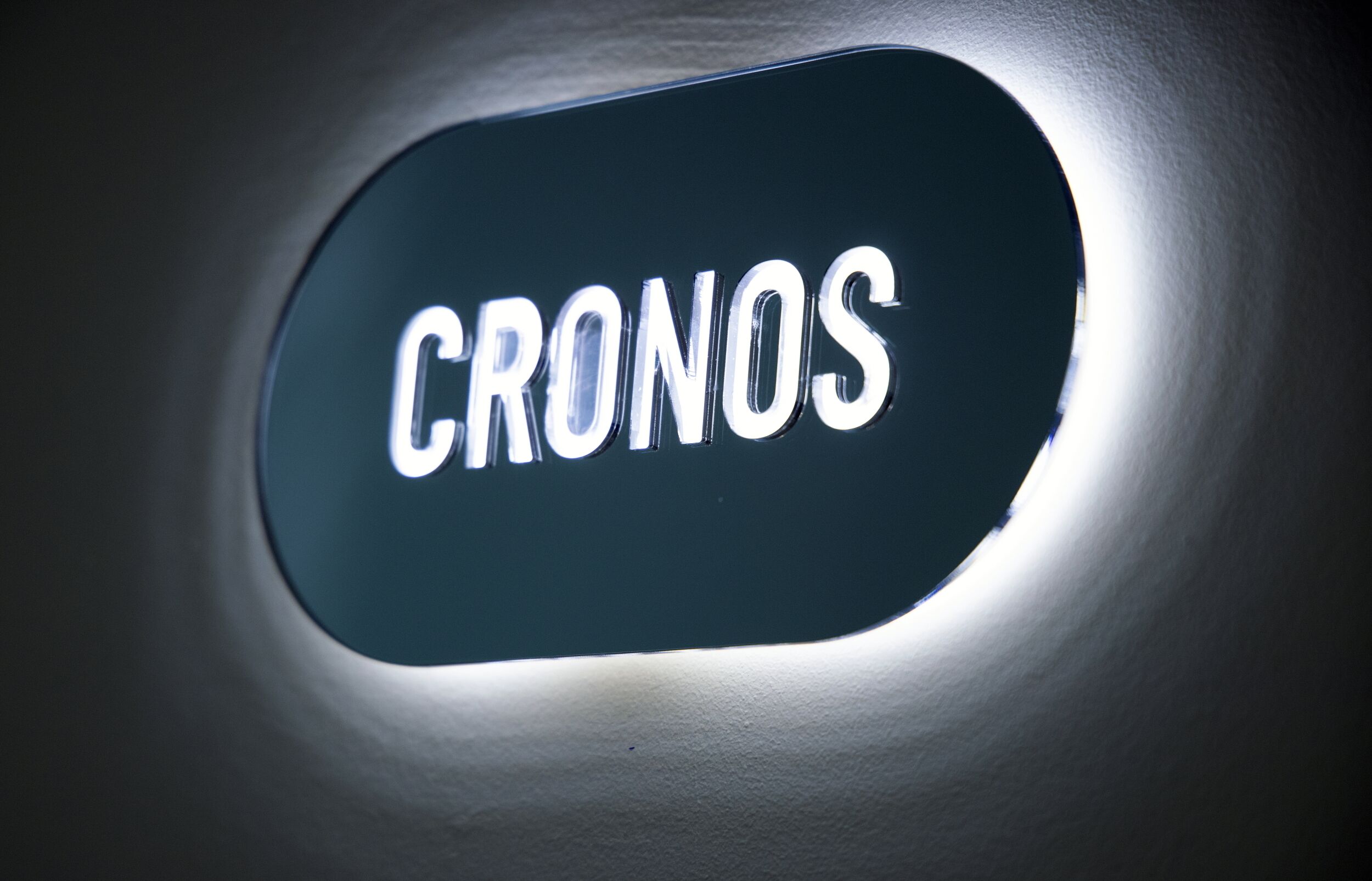 A sign with the word "CRONOS" illuminated in white letters.