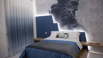 A bedroom with a bed, a nightstand, a large wall mural, and a window with curtains.