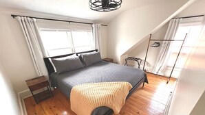 A bedroom with a bed, a wooden floor, a window, and a ceiling fan. - 886 Macon (2 bdrm) · Walkable German Village home w/ fenced yard (Columbus)