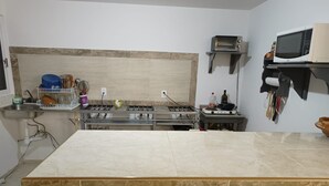 A kitchen with a central island, a microwave, and a stove.