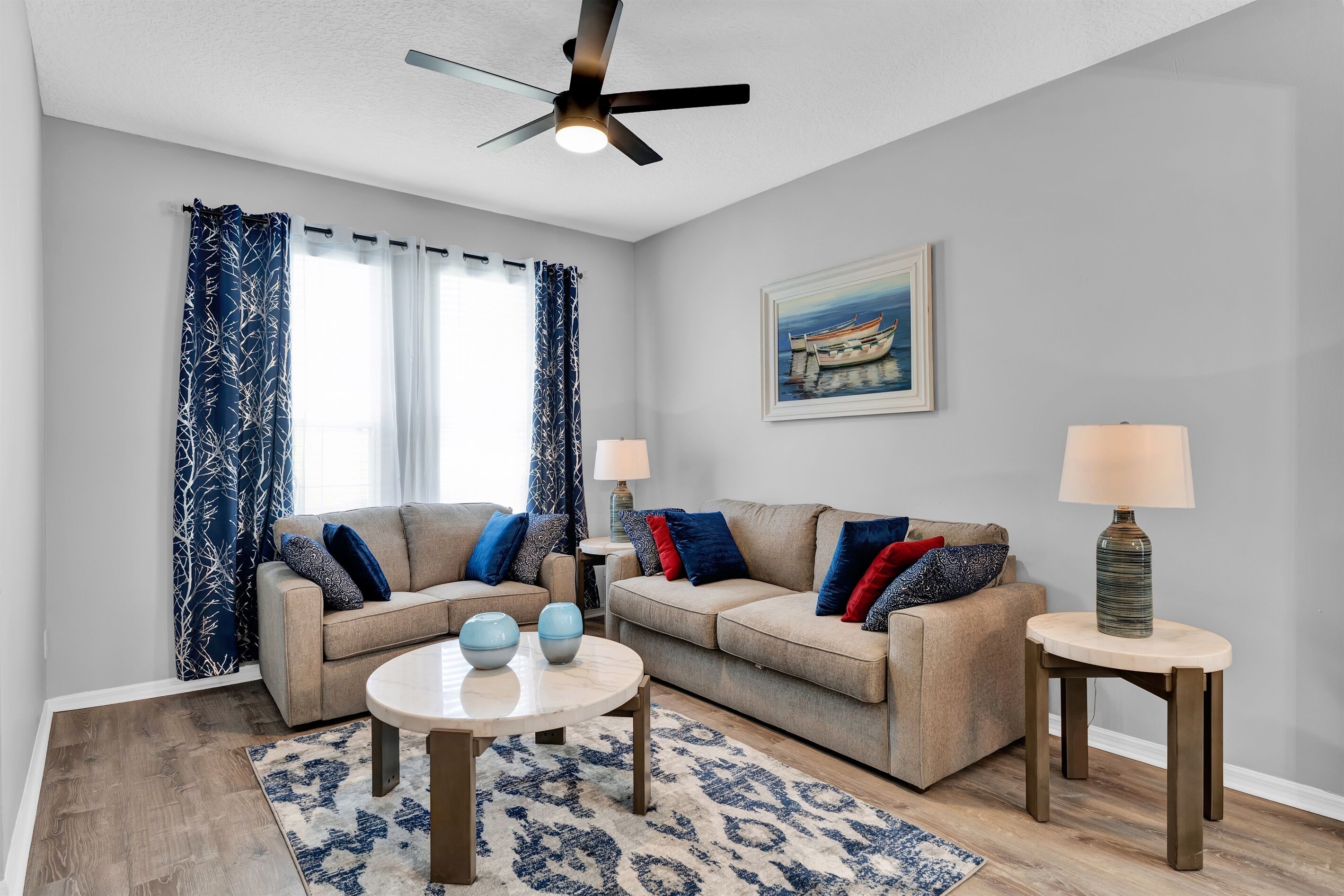 A living room with two sofas, a coffee table, and two lamps.