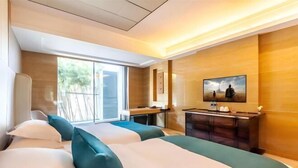 A hotel room with two beds, a desk, a TV, and a sliding door to the outside. - Hongkou Silver Hotel (Tianjin)