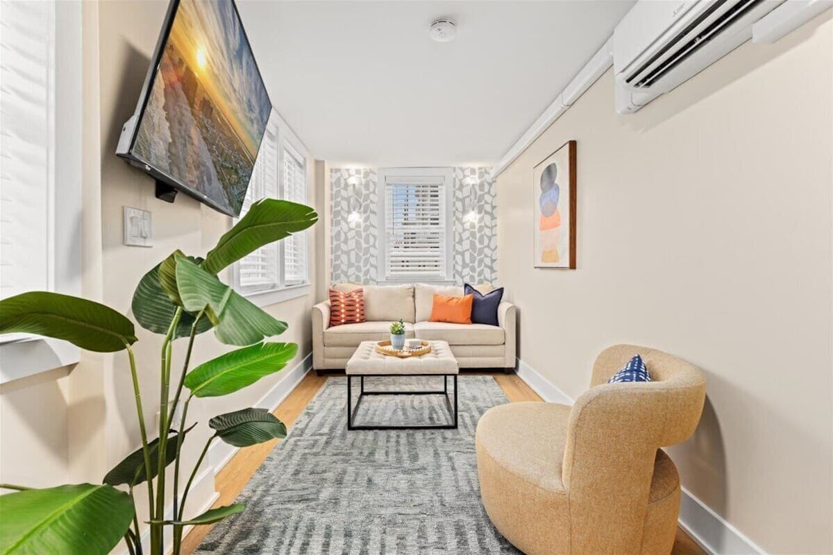 A modern living room with a sofa, coffee table, and a chair.