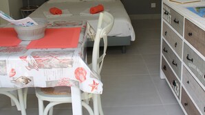 A bedroom with a bed, a desk with a chair, a dresser, and a wall-mounted light fixture. - CLASS 3* STUDIO 1 MINUTE FROM THE BEACH (Andernos-les-Bains)