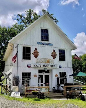 A white building with a sign reading 'Riverlife' and 'C.C. Grover Ray' on the front.