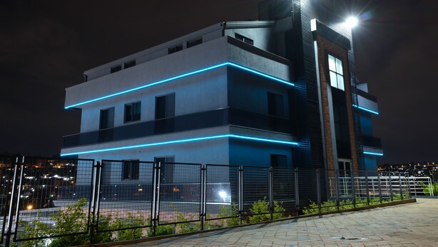 A modern building with a flat roof, multiple windows, and a prominent tower. - Acacus Hotel (Kigali)