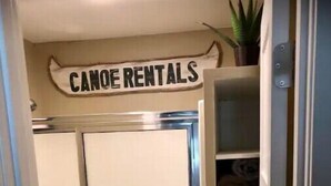 A room with a sign reading "CANOE RENTALS" above a door, indicating a canoe rental service. - #139 Condo near large pool & shuttle to Gorge Amp-book separately (Quincy)