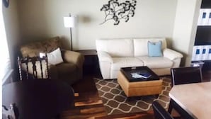 A living room with a sofa, a coffee table, and a patterned rug. - #139 Condo near large pool & shuttle to Gorge Amp-book separately (Quincy)