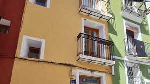 A multi-story building with balconies, a wooden door, and a sign indicating 'Casa Amarilla'. - Raoret House in the Old Town (Villajoyosa)