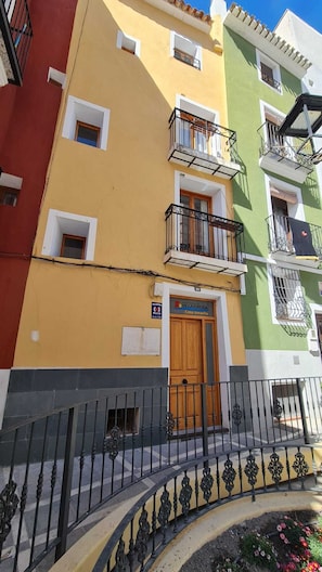 A multi-story building with balconies, a wooden door, and a sign indicating 'Casa Amarilla'. - Raoret House in the Old Town (Villajoyosa)