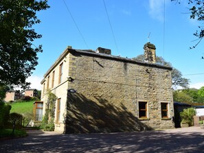 A stone building with a brick facade, a small window, and a chimney. - The Old Post Office - Pet Friendly Group Stays in Holmfirth (Holmfirth)