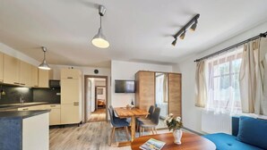 A modern apartment with a kitchen, dining area, and living room. - Marika 1 by Interhome (Cerny Dul)