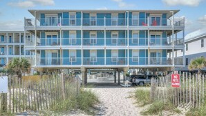 A multi-story beachfront hotel with balconies, a sandy walkway, and a 'No Pets Allowed' sign. - Beachside w/Heated Pool~2BR/1B! (Gulf Shores)