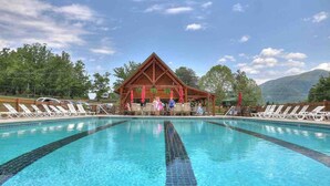A swimming pool with lounge chairs and a wooden pavilion in the background. - 🌟Private🌟Views🌟x2KingSuites🌟HotTub🌟FirePit🌟NationalPark🌟SunSet🌟 (Sevierville)
