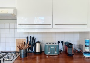 Effortlessly prepare meals in this well-equipped kitchen with a gas stove, toaster, and coffee maker.