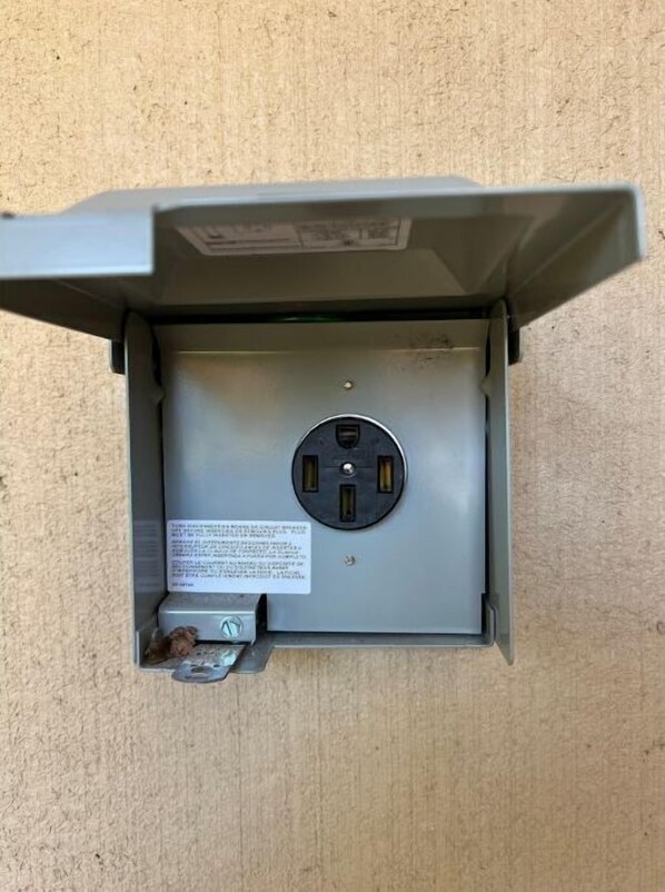 An electrical panel with a visible warning label and a switch.
