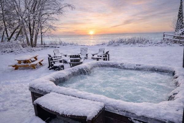 Private hot tub with sunset view, perfect for relaxing winter nights and stargazing in Door County.
