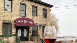 A building with a sign reading "VON STEIHL" at the entrance. - Lakefront Cabin Hot Tub Playground Fire Pit (Algoma)