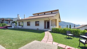 A two-story house with a tiled roof, a paved driveway, and a well-maintained lawn. - 4 bedroom stunning home in Roccadaspide (Roccadaspide)