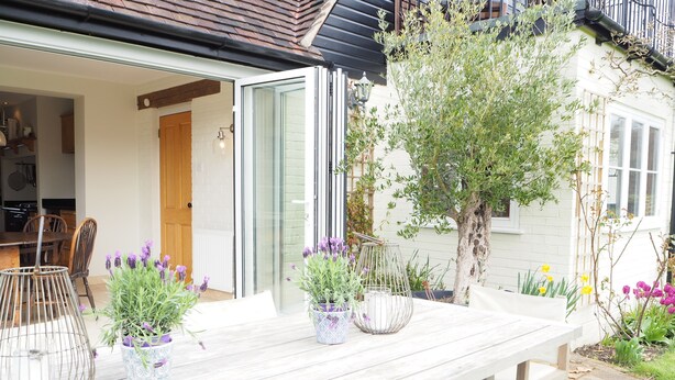 A wooden table with potted plants and a metal birdcage. - Stunning country house (Bix, outside Henley) (Henley)
