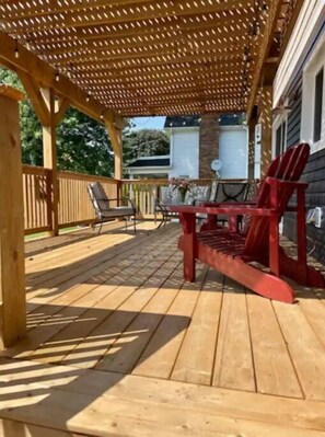 Relax on the outdoor deck with Adirondack chairs and a table, perfect for dining or unwinding.