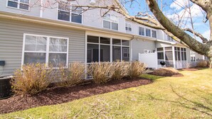 A two-story house with a covered porch, a large window, and a tree in the foreground. - Walk to Outlets & Breweries, Restaurants and community pool (Lewes)