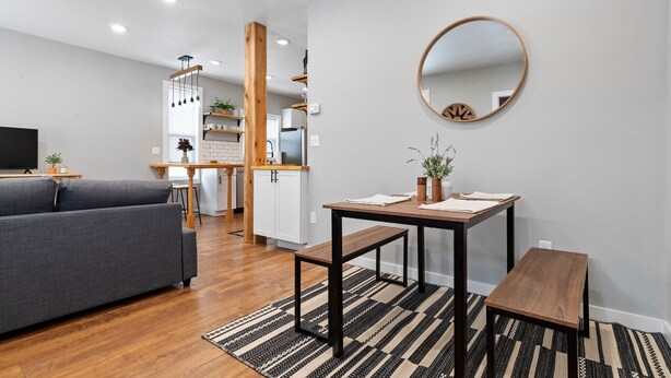 A modern living room with a grey sofa, wooden coffee table, and a black and white striped rug. - Newly Remodeled Downtown Helena Home, Sleeps 11 (Helena)