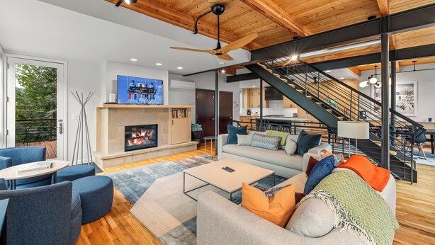 A modern living room with a fireplace, sofa, and coffee table.
