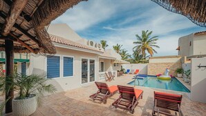 A pool area with lounge chairs and a small inflatable pool. - Villa de Leon, suitable for 14 persons. 5 bedrooms, 5 bathrooms (Noord)
