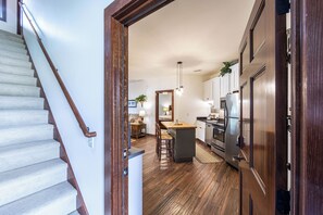 Enjoy cooking in this well-equipped kitchen with a central island, cabinetry, and a stainless steel refrigerator.