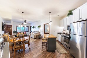 Enjoy meals in the spacious kitchen and dining area, featuring a central island, oven, and refrigerator.
