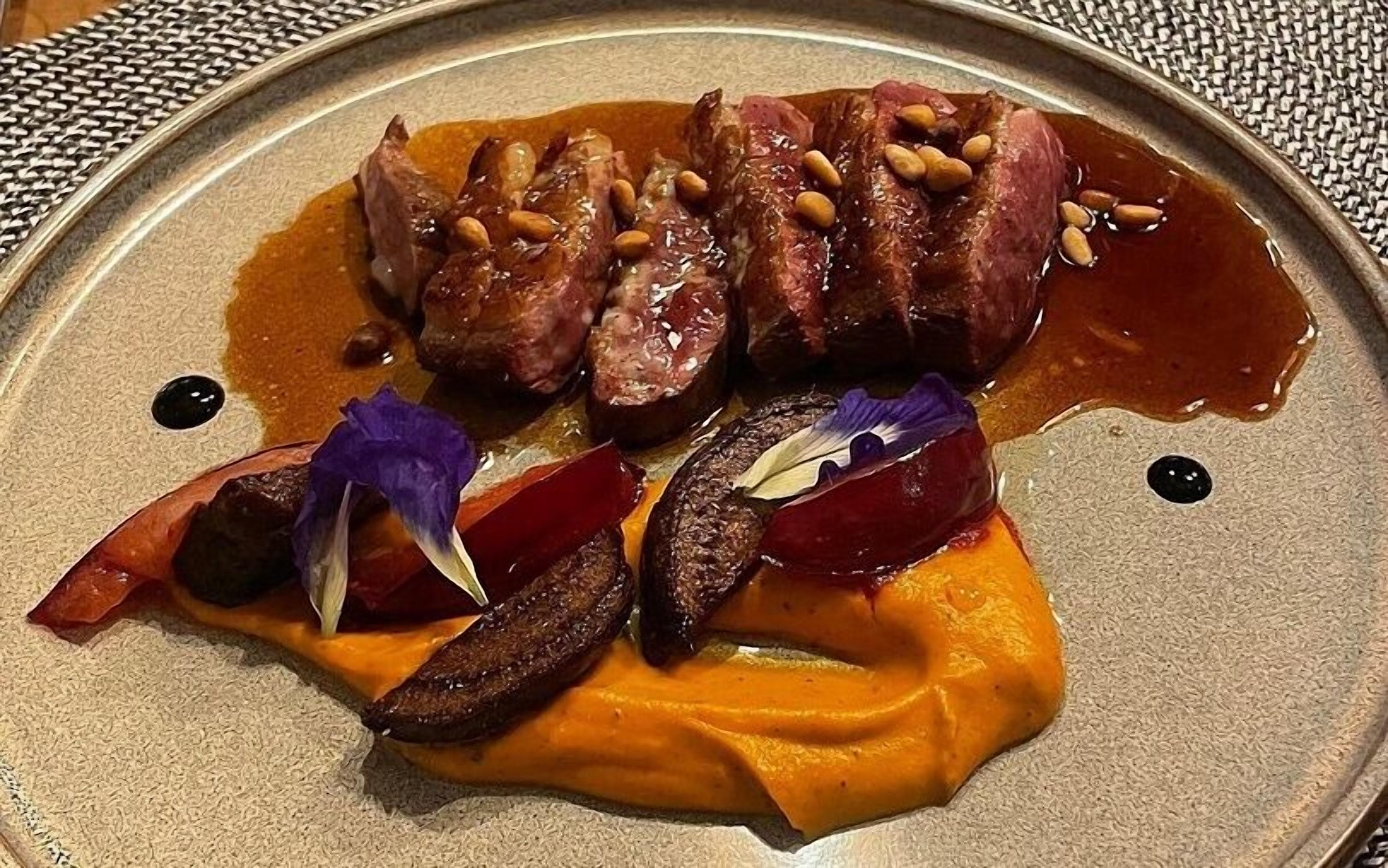 A plate of food with steak, mushrooms, and vegetables.