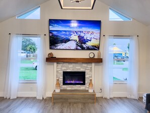 Smart-tv, een open haard, boeken en een stereo