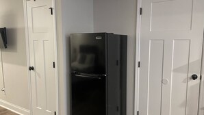 A black refrigerator in a narrow hallway with white doors. - Mid-term rental available - close to all attractions in the Greater Chattanooga and NW Georgia area (Chattanooga)