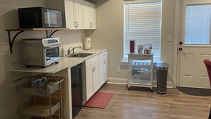 A compact kitchen with white cabinets, a microwave, a toaster, and a small countertop. - Mid-term rental available - close to all attractions in the Greater Chattanooga and NW Georgia area (Chattanooga)