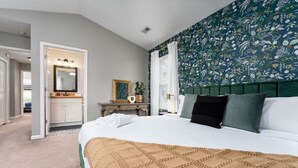A bedroom with a large bed, a nightstand, a dresser, and a mirror. - Beach Time! w/ King Beds, Pool, Fire Pit, & Tennis (Wilmington)