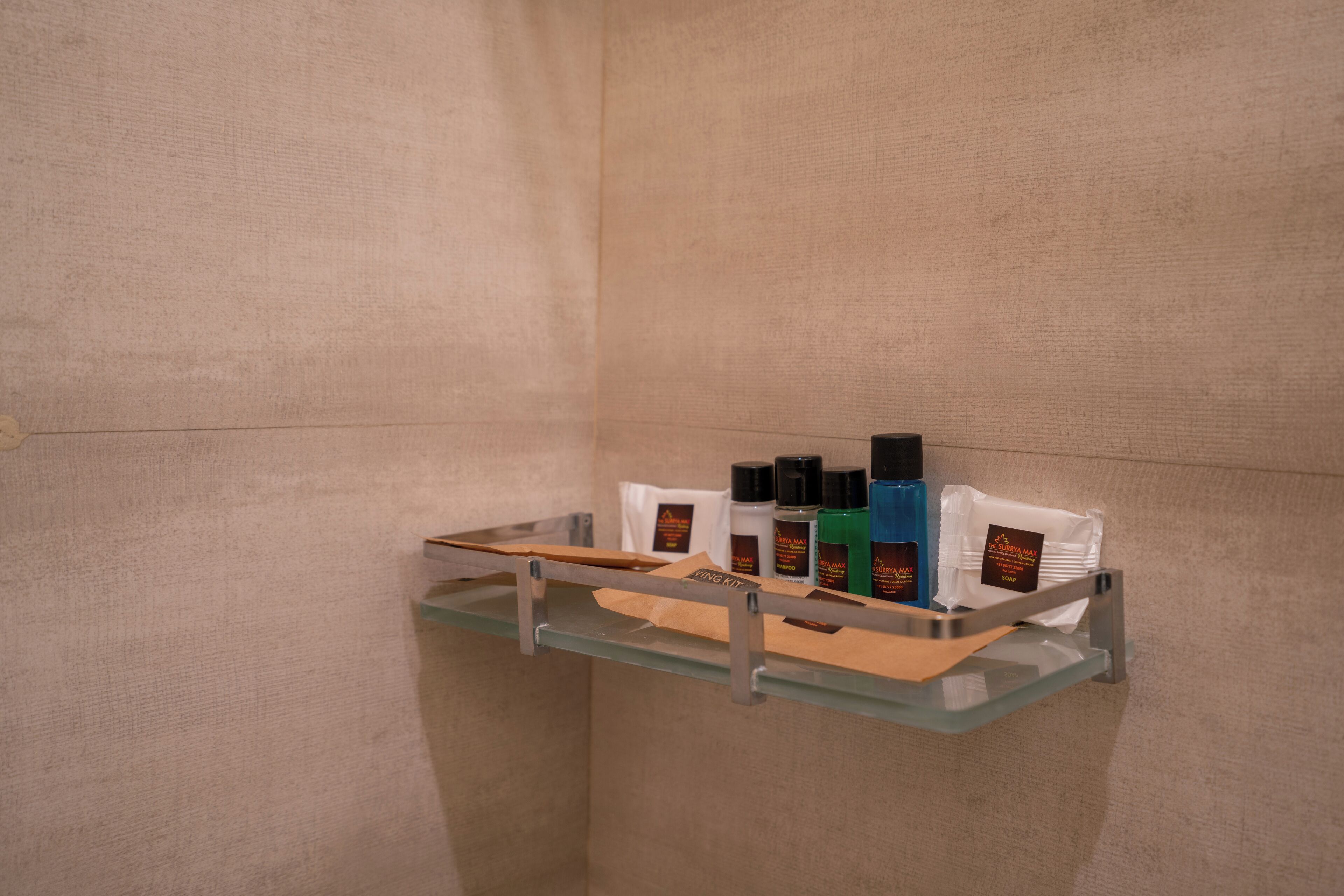 A bathroom with a glass shelf holding toiletries.
