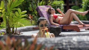 A poolside area with lounge chairs and greenery. - Sueno Dorado Hot Springs Hotel (La Fortuna)