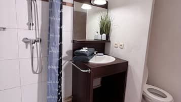 Een haardroger, handdoeken, zeep, toiletpapier