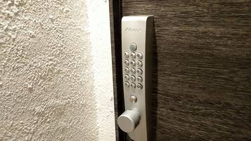 A modern door with a keypad lock and a keyhole.