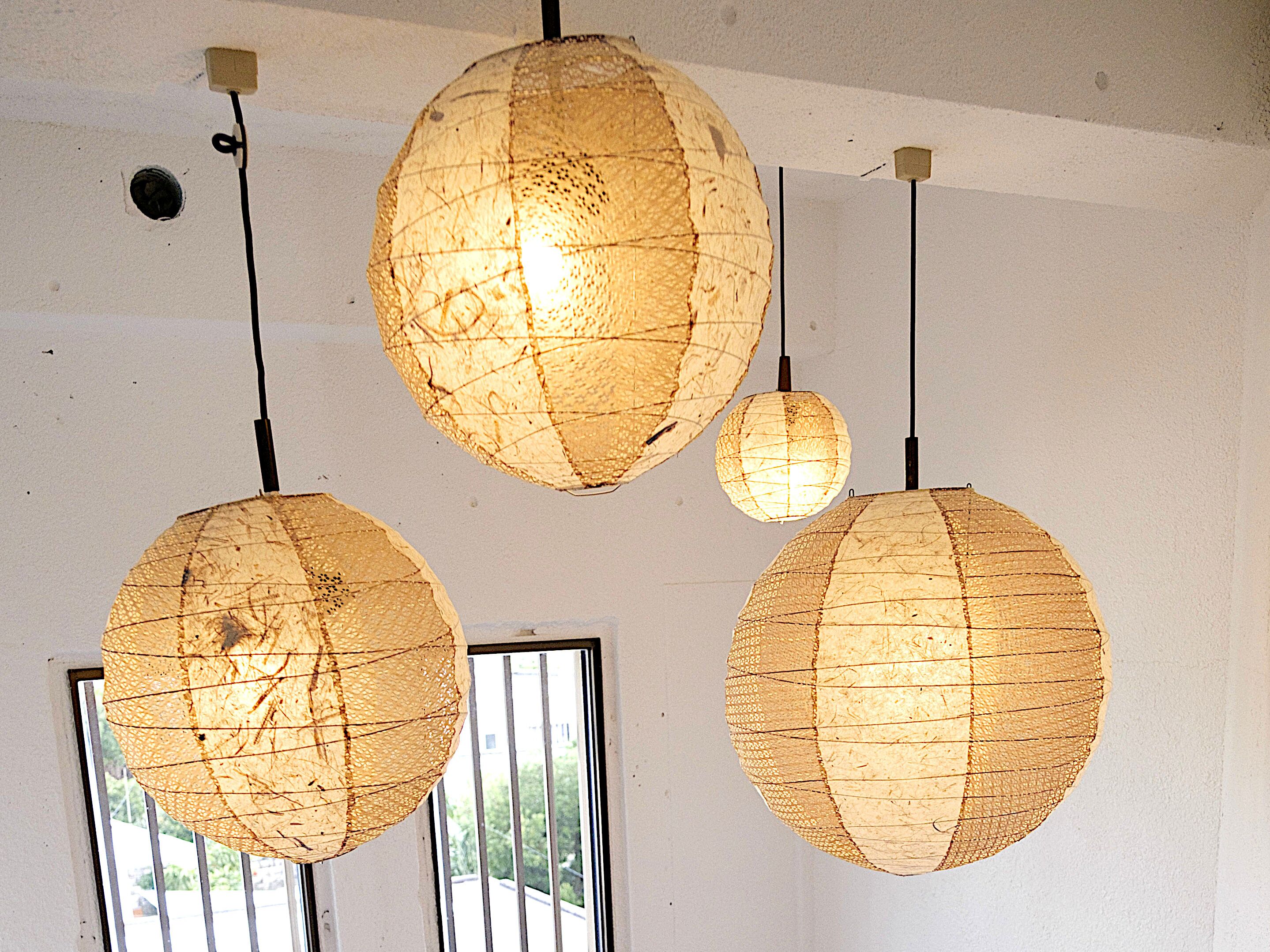 Three spherical paper lanterns hanging from the ceiling.