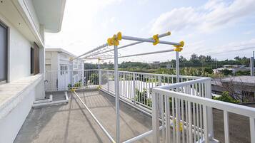 A balcony with a metal railing and a view of the surrounding area.