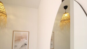 A hallway with two framed pictures on the walls and two hanging lamps with a woven texture. - Modern Duplex Apartment Near Beach & Center - Del Parque Flats Constancia V3 (Málaga)