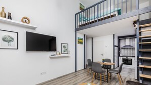 A modern apartment with a loft bedroom, a dining area, and a kitchen. - Venus Apartments - Westside Residence (Budapest)