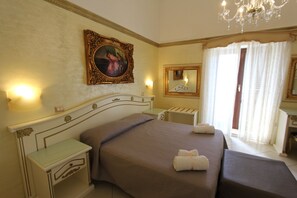 A hotel room with a large bed, bedside tables, a chandelier, a painting, and a mirror. - DIO DEL MARE LUXURY ROOM (Porto Cesareo)