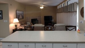 A kitchen with white cabinets, a central island, and a ceiling fan. - 2 BEDROOM CONDO IN THE HEART of OSAGE BEACH at the LAKE!!! (Osage Beach)