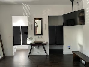 Relax in a contemporary space with a bench, wall-mounted TV, and ambient lighting.