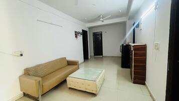 Deluxe Double Room | Living area | 32-inch LCD TV with cable channels, TV, DVD player